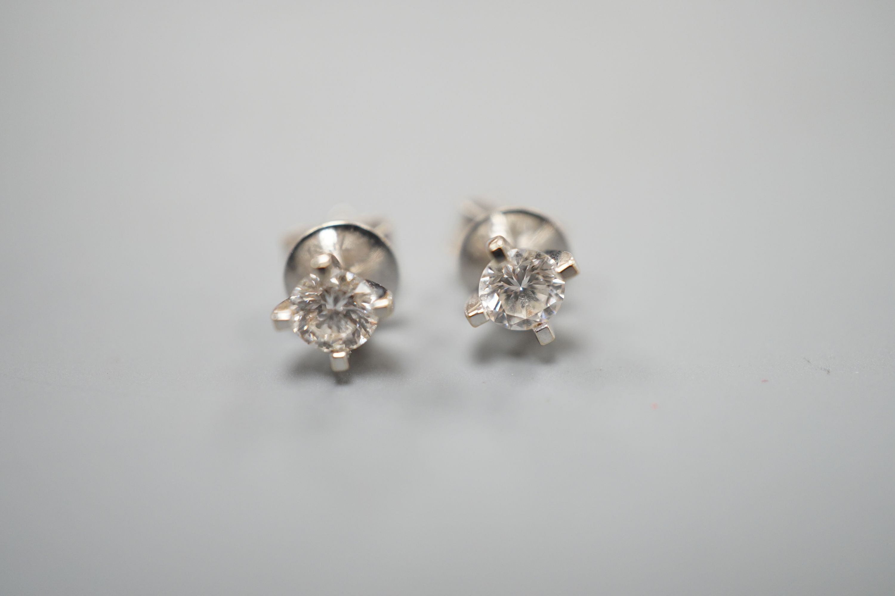 A pair of 750 white metal and solitaire diamond set ear studs, the stones measuring 3.5mm in diameter, gross weight 1.1 grams.